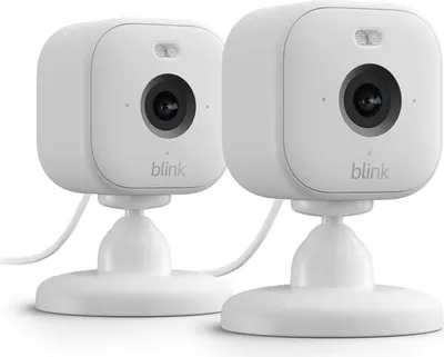 Two white Blink Mini 2 smart security cameras are shown on a white background.