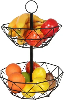 A two-tiered black metal fruit basket filled with various fruits.