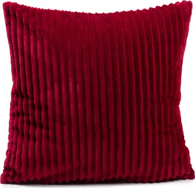 A red corduroy pillow on a white background.
