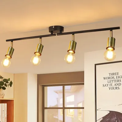A four-bulb ceiling light fixture with black metal bar and gold accents, mounted on a white ceiling.