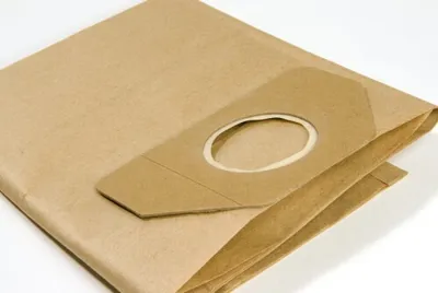 A close-up shot of a folded brown paper vacuum cleaner bag on a white background.