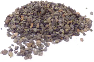 A pile of small, irregular-shaped, gravel-like material on a white background.