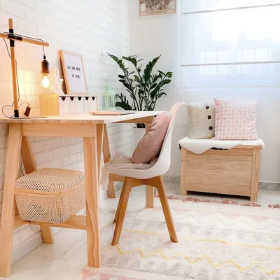A cozy home office or study area with a wooden desk, chair, and storage.