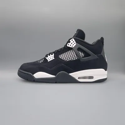 A side view of a black and white Nike Air Jordan 4 Retro sneaker against a plain gray background.