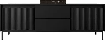 A black TV lowboard with fluted doors and drawers, with a small electronic device on top.