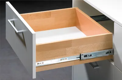 An open drawer with wooden interior and metal drawer slides.
