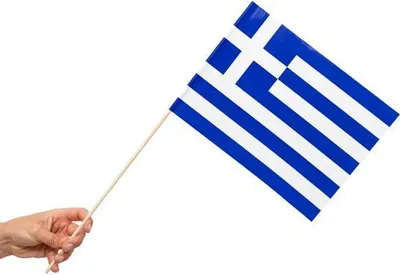 A hand holding a small flag of Greece on a white background.