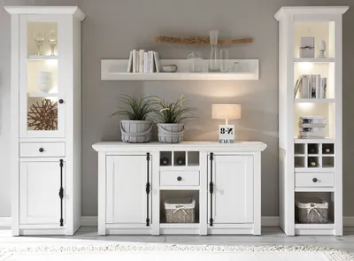 A white modular living room furniture set against a light gray wall.
