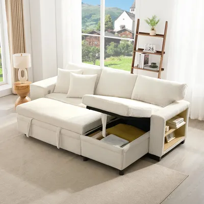 A beige sectional sofa with a chaise lounge that opens for storage, set in a bright living room with a window view of a village and mountains.