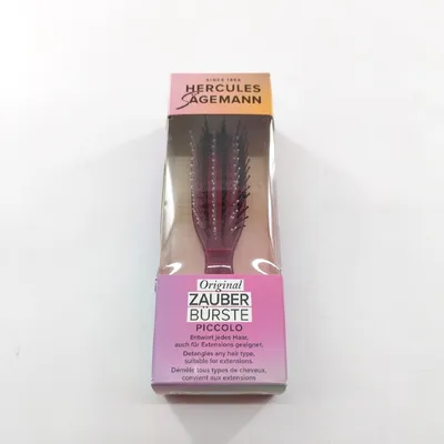 A packaged hair brush is shown against a white background.