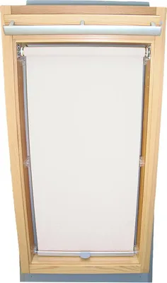 A white roller blind is installed in a wooden framed skylight window.