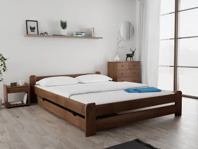 A bedroom scene with a wooden bed, nightstand, and dresser.