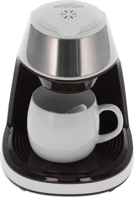 A single-serve coffee maker with a mug placed underneath the brewing spout.