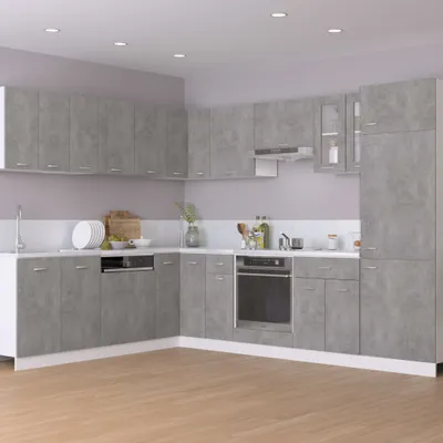 A modern kitchen with gray cabinets and a white countertop.