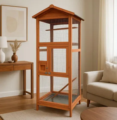 A wooden bird cage is shown in a living room setting, next to a sofa and a wooden table.