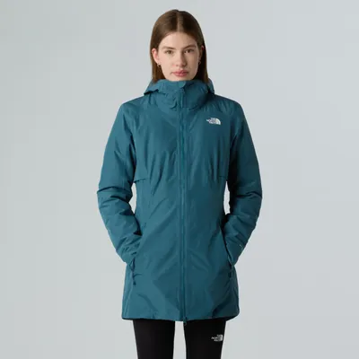A woman is modeling a teal parka jacket.