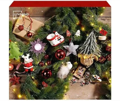 A festive arrangement of Christmas decorations, including ornaments, a small tree, and gift boxes, intertwined with a fir garland and fairy lights, set against a rustic wooden background.