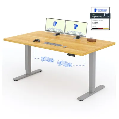 A standing desk with two monitors, a keyboard, and a controller.