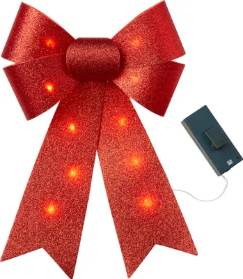 A red glitter bow with embedded red LED lights and a battery pack.