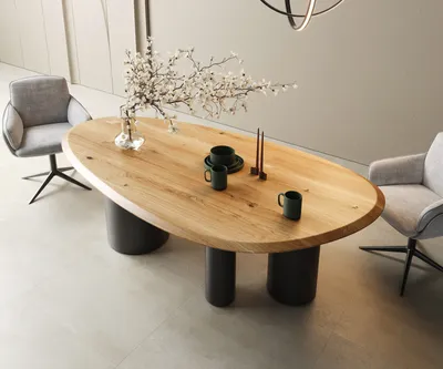 A modern dining room setting with an oval wooden table and chairs.
