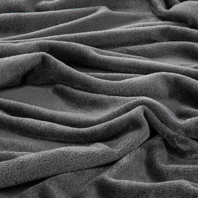 A close-up view of a folded, dark gray blanket.