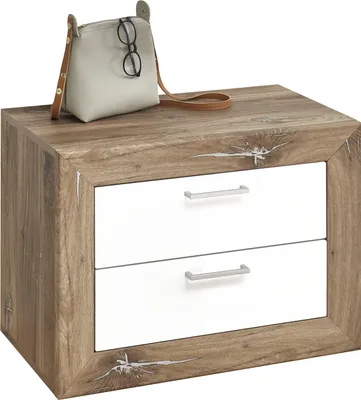 A bedside table with two drawers and a handbag with glasses on top.