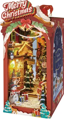 A 3D wooden puzzle book nook depicting a Christmas street scene.