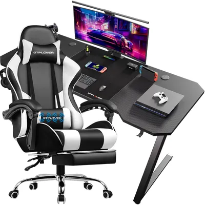 A gaming desk and chair set with a monitor, keyboard, mouse, and gaming consoles.