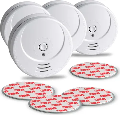 A group of white smoke detectors with adhesive pads.