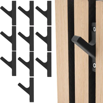 A collection of black coat hooks arranged in a grid next to a wooden panel with integrated hooks.