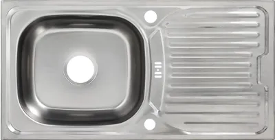 A top-down view of a stainless steel kitchen sink with a drainboard.