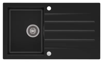 A top-down view of a black granite kitchen sink with a drainer.