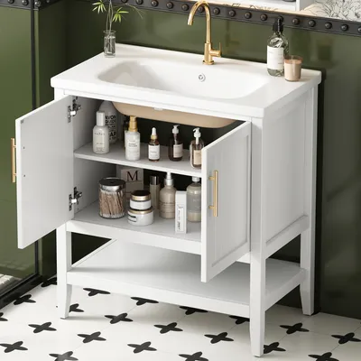 A white bathroom vanity with open doors and shelves, displaying various toiletries and cleaning products. A gold faucet is visible on the white sink.
