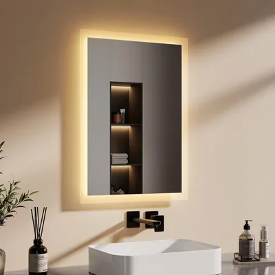 A modern bathroom vanity with a lit mirror, sink, and faucet.