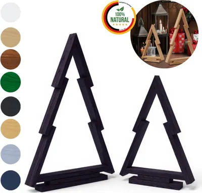 Two black wooden Christmas trees are displayed against a white background, with a circular marketing graphic in the upper right corner. A smaller inset image shows natural wood Christmas trees in a festive setting.