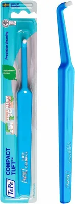 A blue TePe Compact Tuft interdental brush in its packaging, shown next to the brush itself.