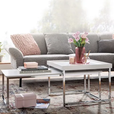 A living room scene with a sofa and nesting coffee tables.