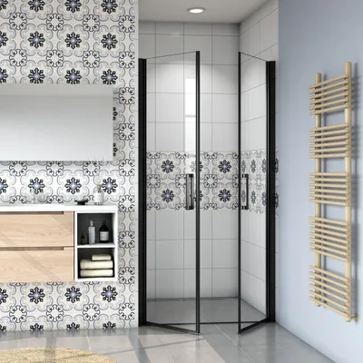 A modern bathroom with a shower cabin, vanity, and a towel rack.