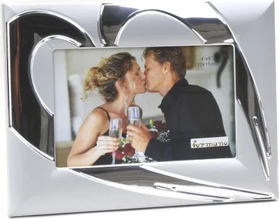 A silver heart-shaped photo frame with a picture of a couple kissing.
