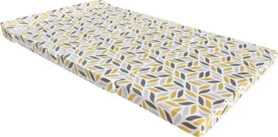 A mattress with a geometric pattern lies diagonally on a white background.