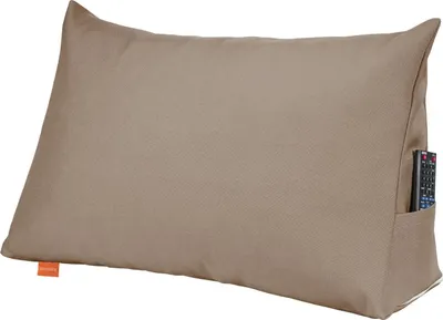 A beige wedge pillow with a remote control in its side pocket, shown against a white background.