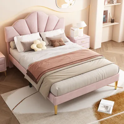 A pink upholstered bed with a shell-shaped headboard in a bedroom setting.