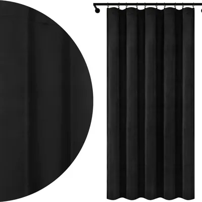 A black velvet curtain hanging from a curtain rod.