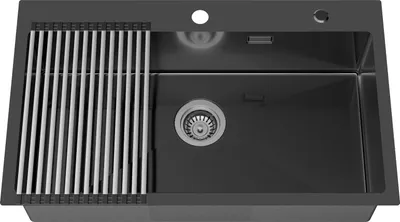 A dark gray kitchen sink with a silver draining rack.