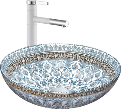 A white faucet is positioned behind a decorative basin.