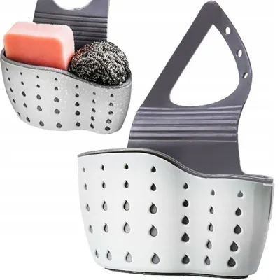 Two kitchen sink organizers are shown against a white background. One organizer is in the foreground and is empty, while the other is in the background and contains a bar of soap and a scrub brush.
