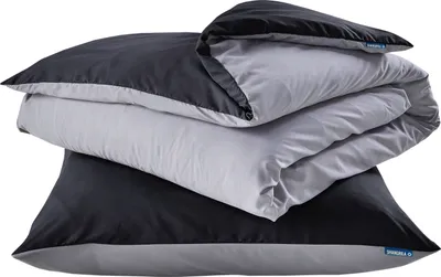A stack of folded bedding, including a duvet and pillow, in black and gray.