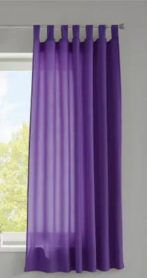 A purple curtain hanging on a curtain rod in front of a window.