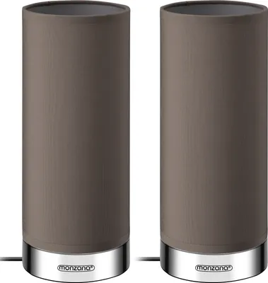 Two identical taupe cylindrical table lamps with silver bases are shown side-by-side against a white background.