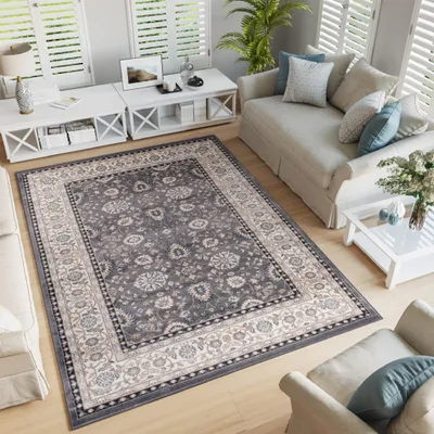 A living room scene with a rug, sofa, and coffee table.